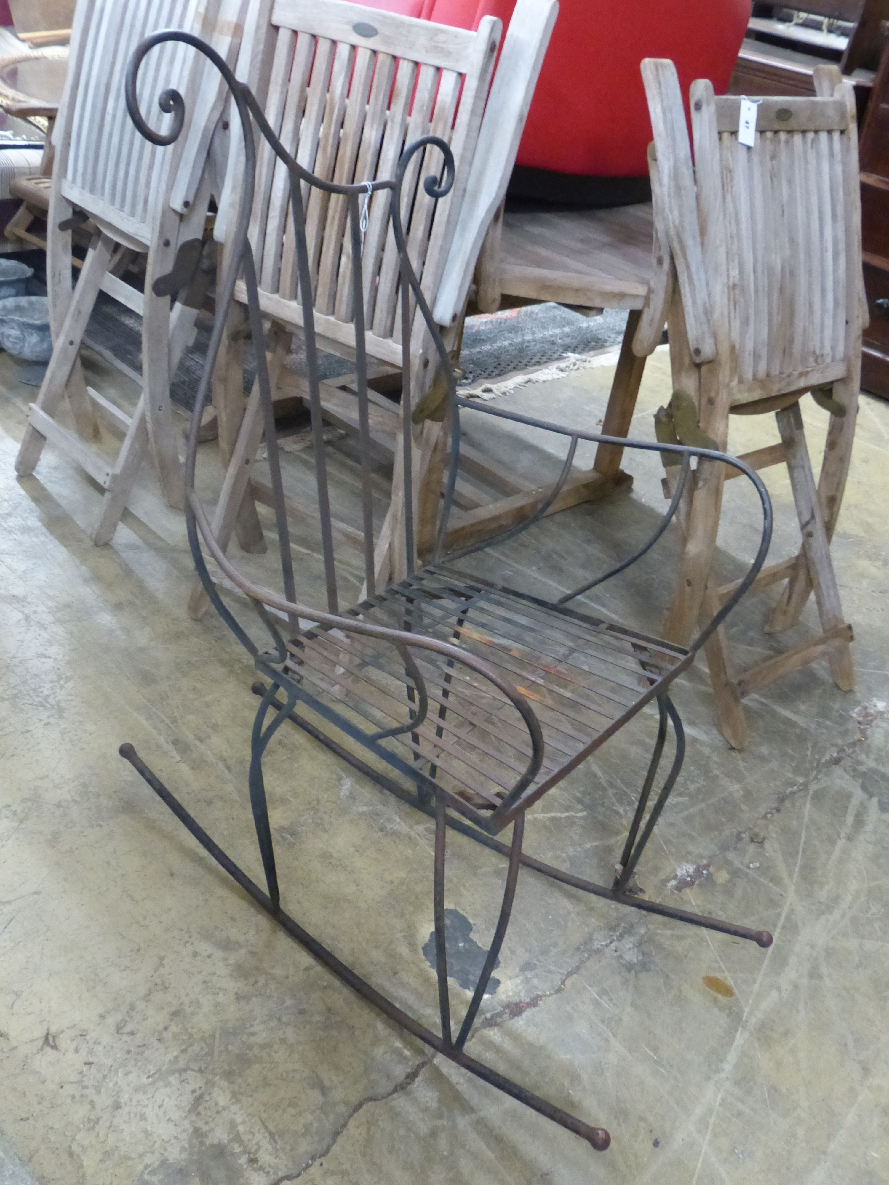 A contemporary wrought iron rocking chair, width 66cm, height 119cm